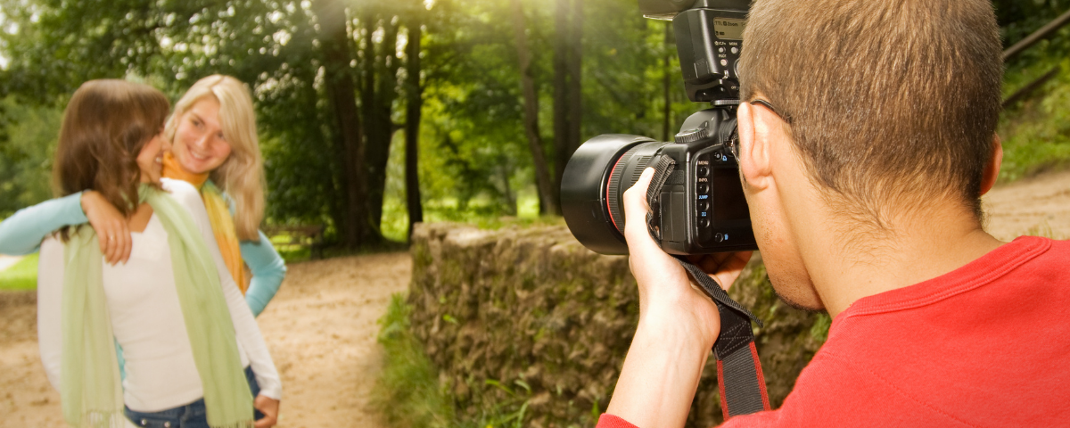 photographer capturing photo of two women outdoors